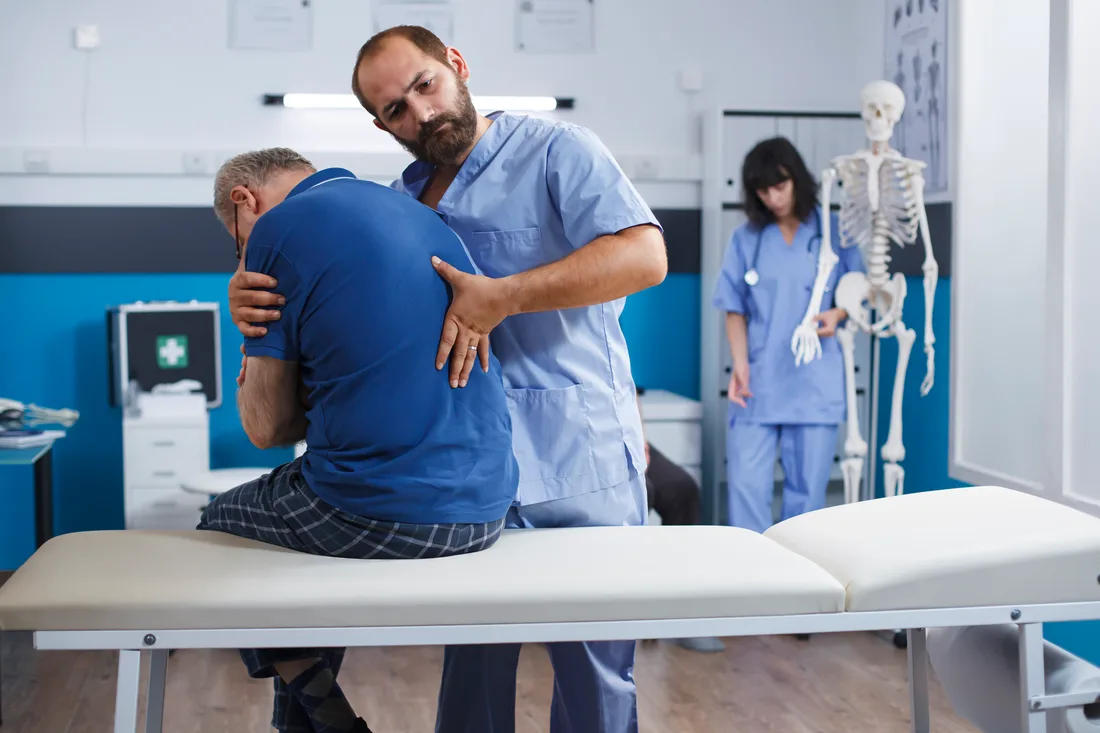 A chiropractor treating a patient’s back in a clinic