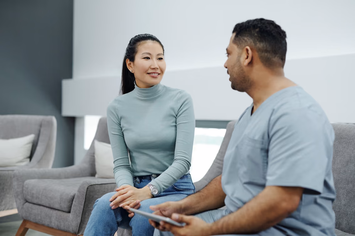 A clinician and patient in a care setting