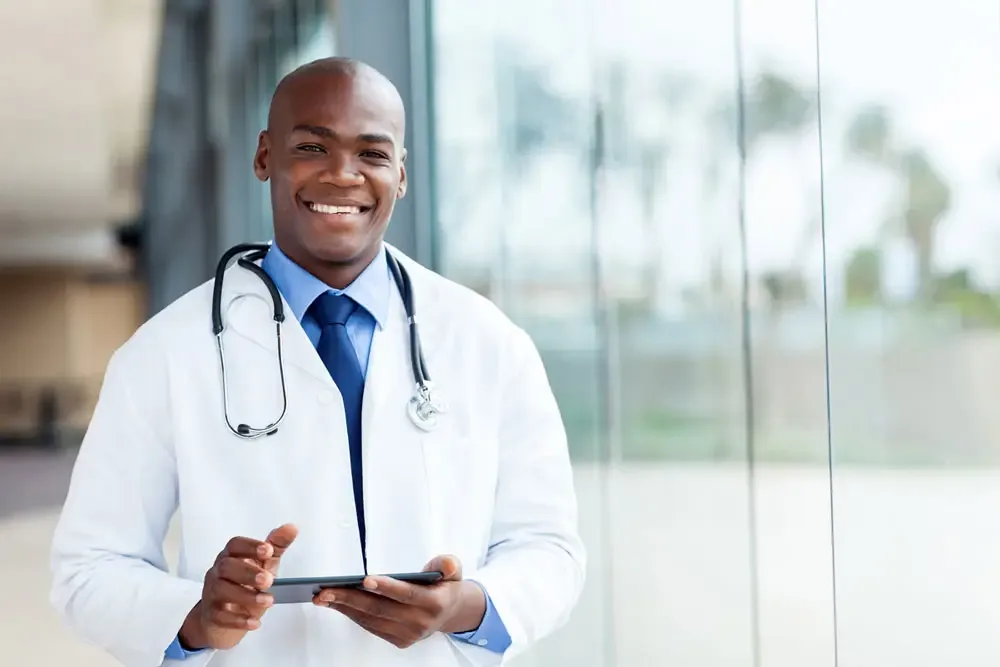 A primary care physician reviewing a patient record on a tablet
